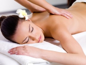 Beautiful woman having relaxing massage on her back in spa salon